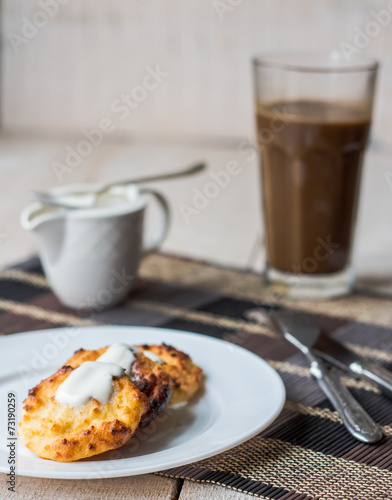 cottage cheese pancakes with sour cream and coffee, breakfast