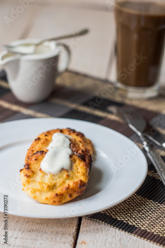 cottage cheese pancakes with sour cream and coffee, breakfast