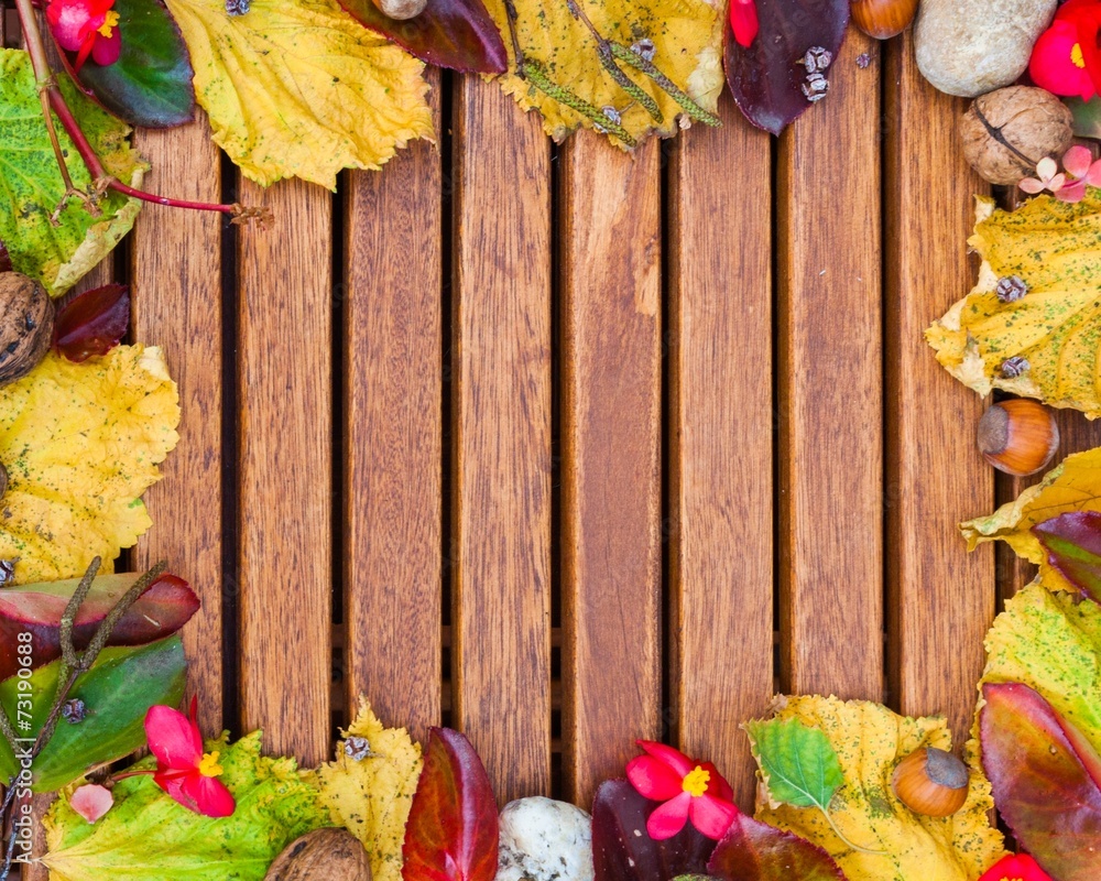 The background of autumn leaves on a wooden surface