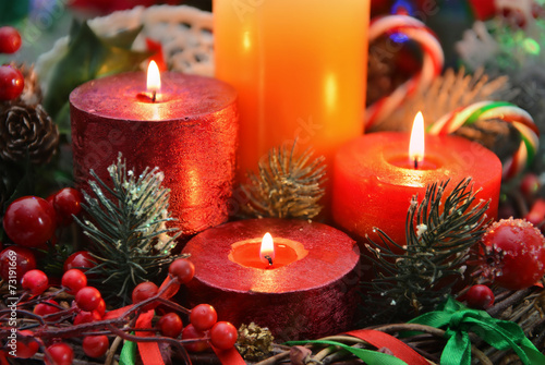 Christmas candles with traditional decorations, close up