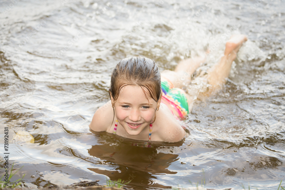 Pretty nice little girl swimming in lake Pretty nice little girl swimming in lake