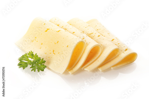 Swiss Tilsit cheese slices garnished with parsley photo