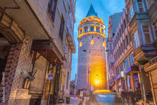 Beautiful sunset view of Galata Tower framed by street buildings