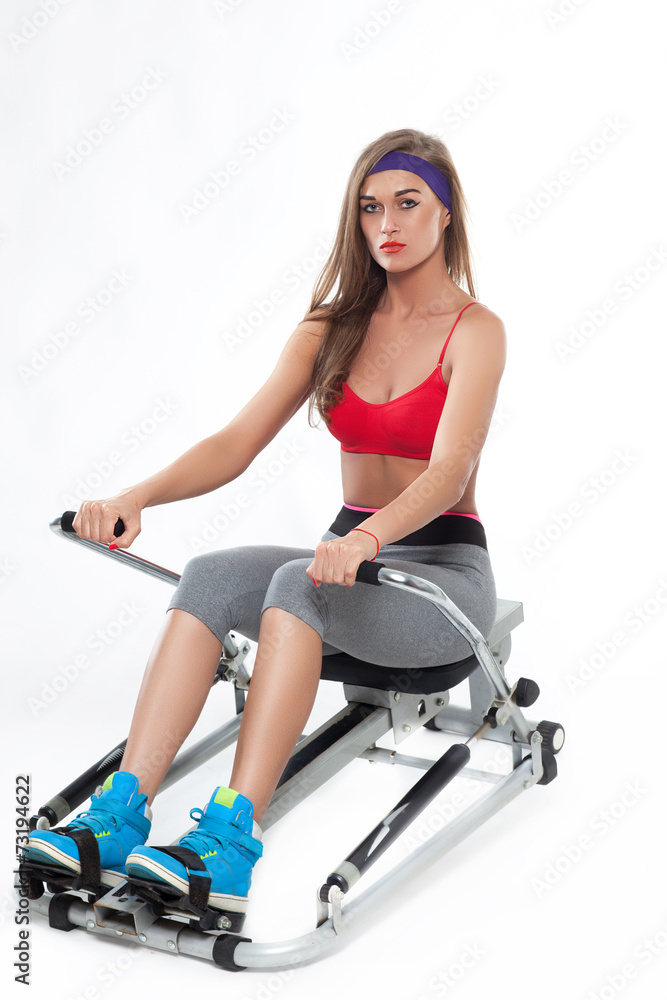Sporty woman in gym isolated on white background Sporty woman in gym isolated on white background