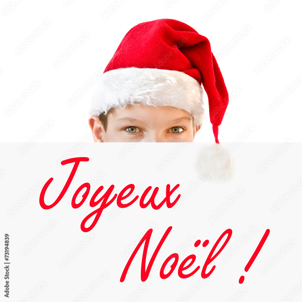 Young boy in red Santa hat and Joyeux Noel - obrazy, fototapety, plakaty 