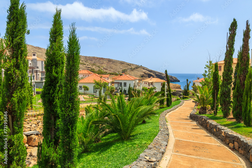 Alley in tropical gardens with holiday villas on Madeira island