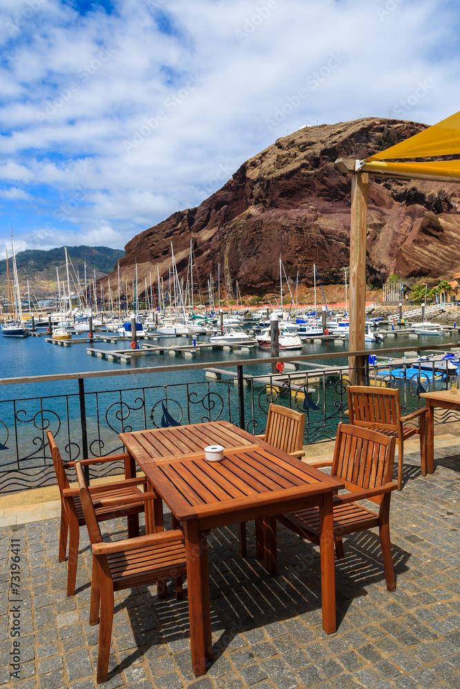 Chairs and table in harbour with yacht boats, Madeira island Chairs and table in harbour with yacht boats, Madeira island