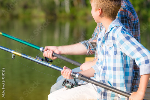 Close-up of hands of a boy with a fishing rod