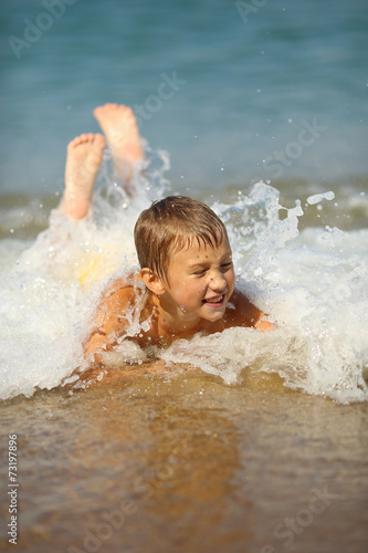 kid in the foam of waves © komi$ar