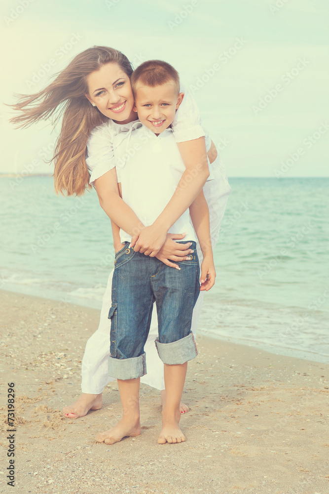 Mother and her son having fun on the beach