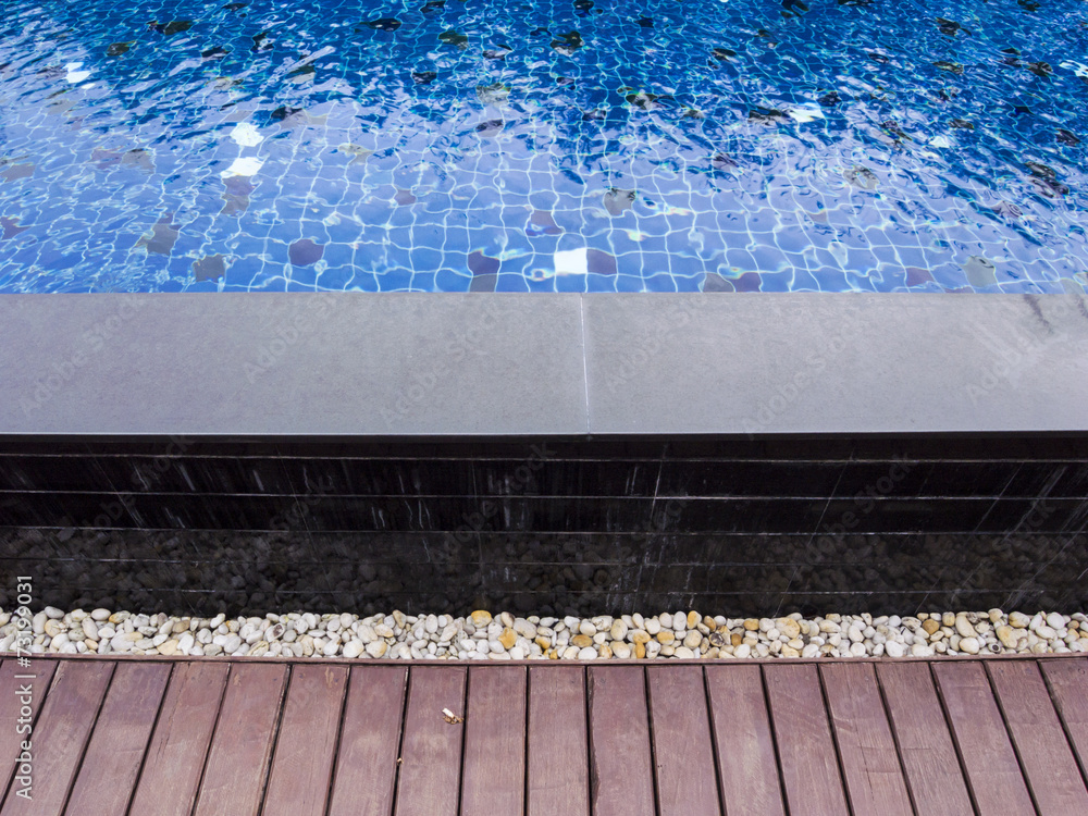 Naklejka premium Swimming pool with wooden and stone