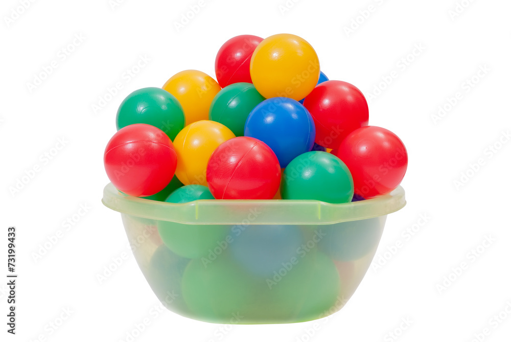 Colorful plastic toy balls into green washbow lisolated on white Colorful plastic toy balls into green washbow lisolated on white