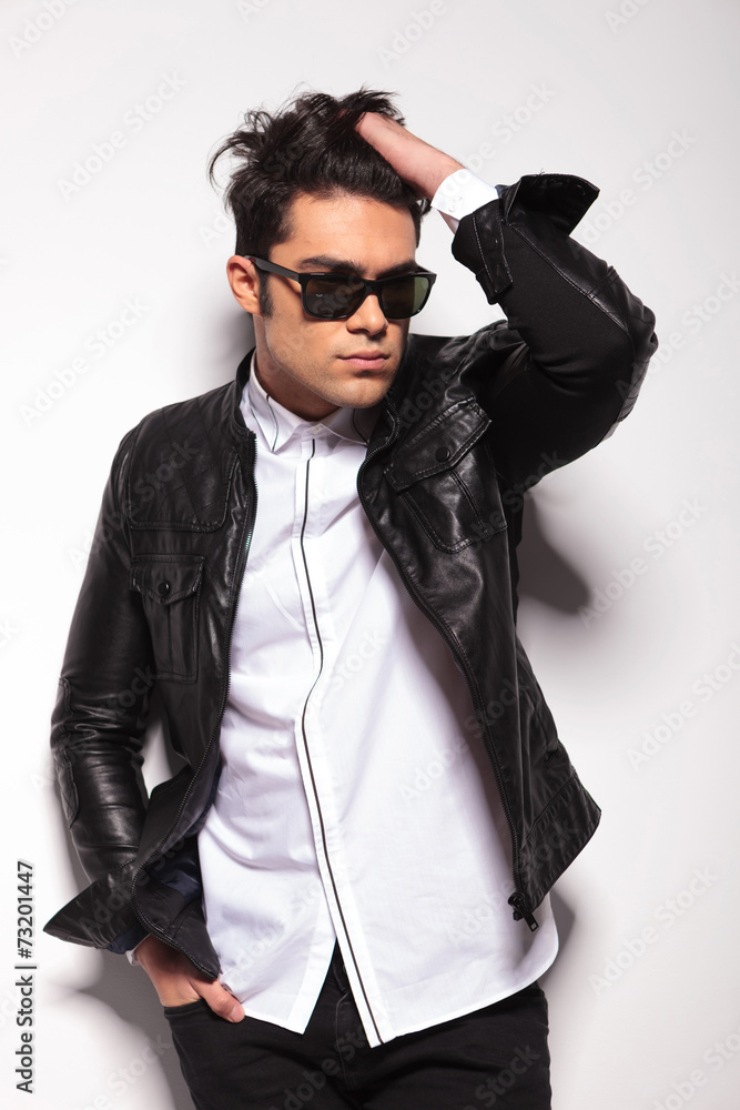 Fashion young man fixing his hair Fashion young man fixing his hair