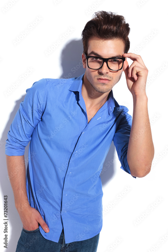 business man fixing his glasses while looking at the camera business man fixing his glasses while looking at the camera