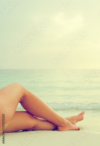 Woman lying on the beach. Vintage effect.