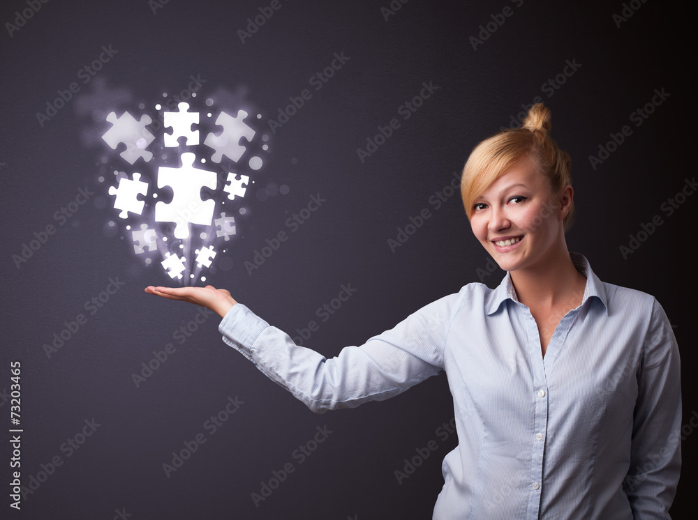 Puzzle pieces in the hand of a businesswoman Puzzle pieces in the hand of a businesswoman