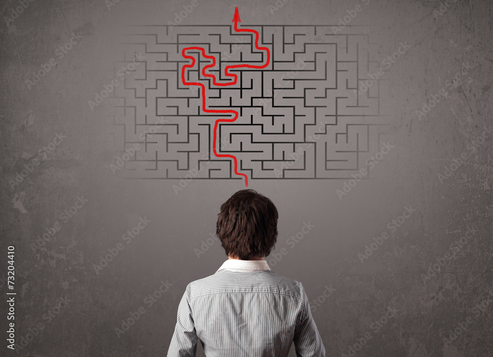 Business man looking at a maze and the way out Business man looking at a maze and the way out
