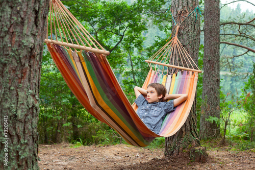 Child relaxing in hammock outdoors