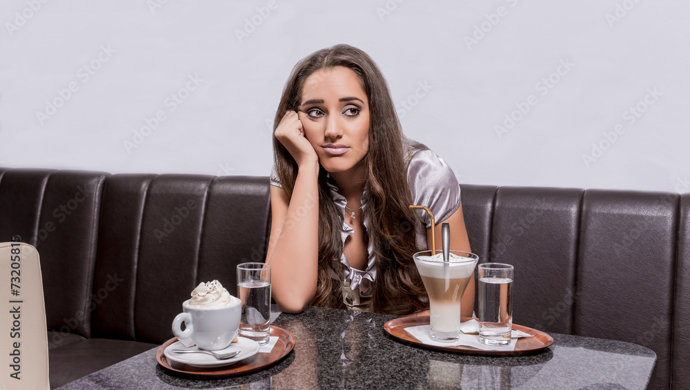 Portrait of a cute smiling woman sitting in a cafe Portrait of a cute smiling woman sitting in a cafe