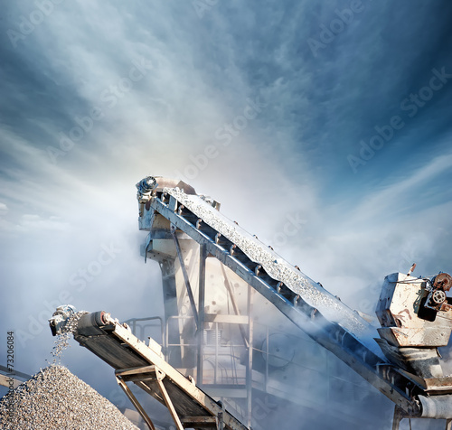 Heavy machinery of gravel production in quarry. Stones breaking