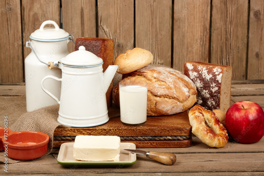 Fresh bread and butter and milk on wooden background Fresh bread and butter and milk on wooden background