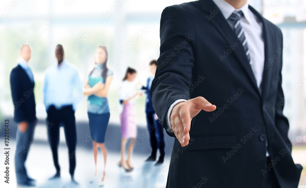 A business man with an open hand ready to seal a deal A business man with an open hand ready to seal a deal