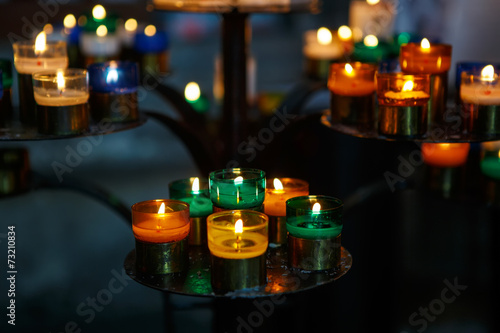 Church candles in red, green, blue and yellow transparent chande photo
