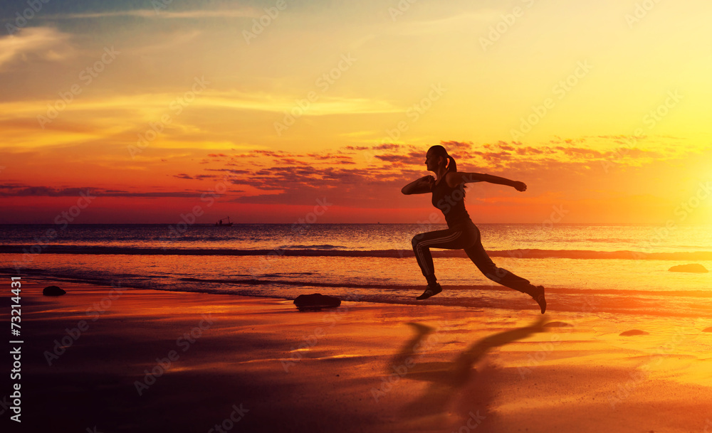 Healthy fitness woman running at sunset