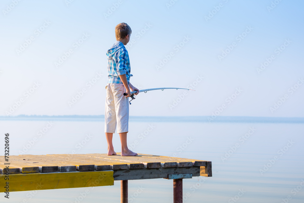 Boy in blue shirt standing on a pie Boy in blue shirt standing on a pie