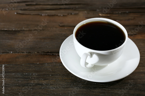 Cup of coffee on wooden table