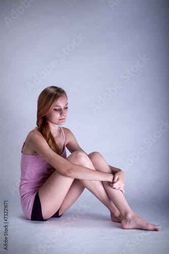 Depressed woman sitting on the floor