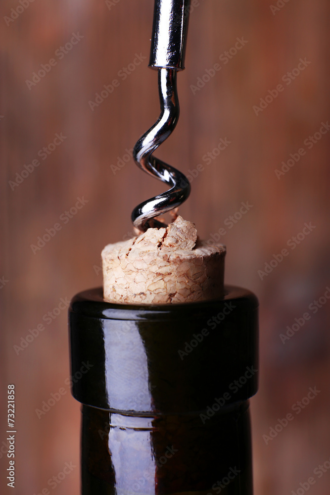 Bottle opener close-up, on wooden background Bottle opener close-up, on wooden background