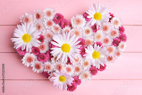 Fototapeta Naklejka Na Ścianę i Meble -  Beautiful flowers in heart shape on wooden background