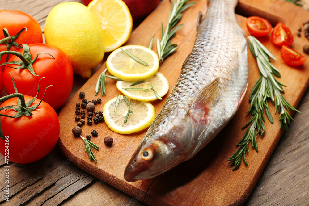 Fresh raw fish and food ingredients on table Fresh raw fish and food ingredients on table