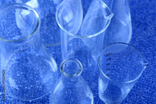 Different laboratory glassware on color background