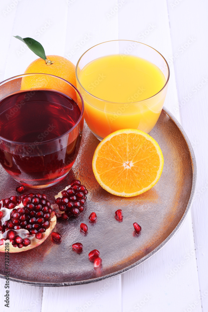 Glasses of fresh orange and pomegranate juice Glasses of fresh orange and pomegranate juice