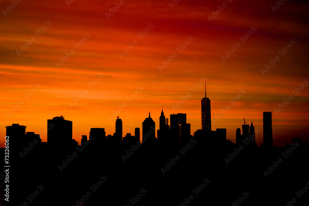 Silhouette of downtown Manhattan skyline at sunset