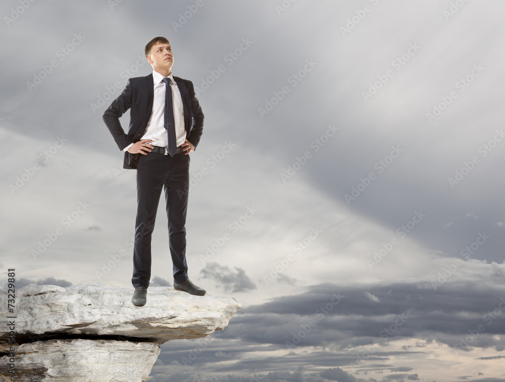 Businessman standing on a peak Businessman standing on a peak