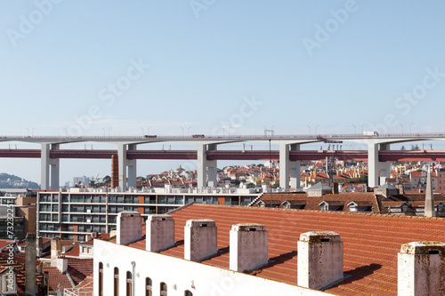 25 de Abril Bridge close-up and Lisbon cityscape