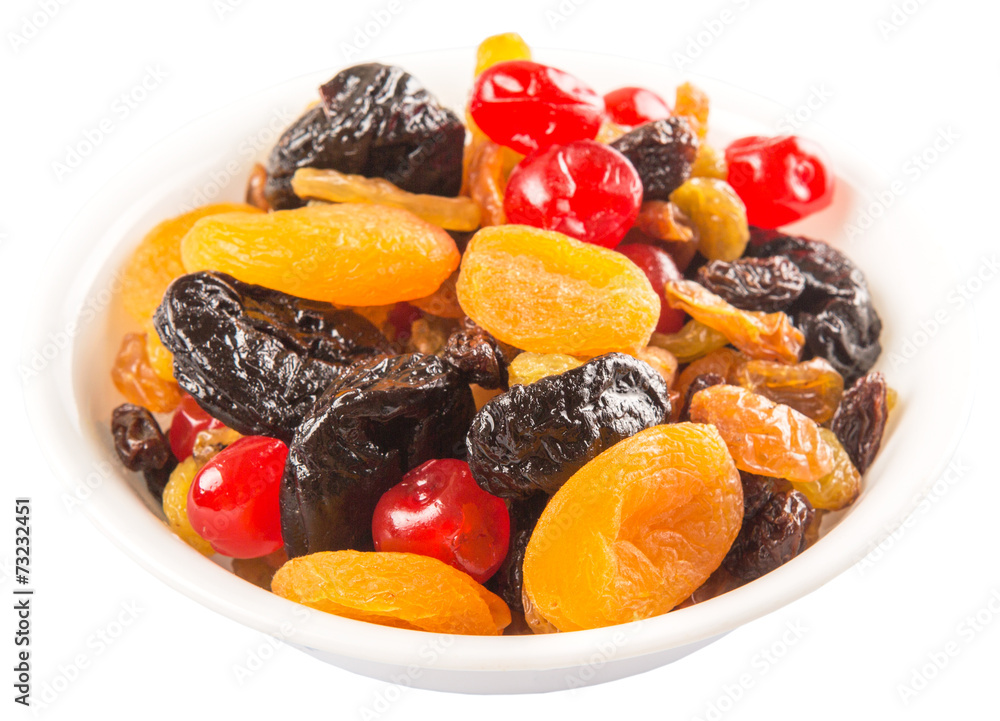 Mix variety of dried fruit in white bowl over white background Mix variety of dried fruit in white bowl over white background