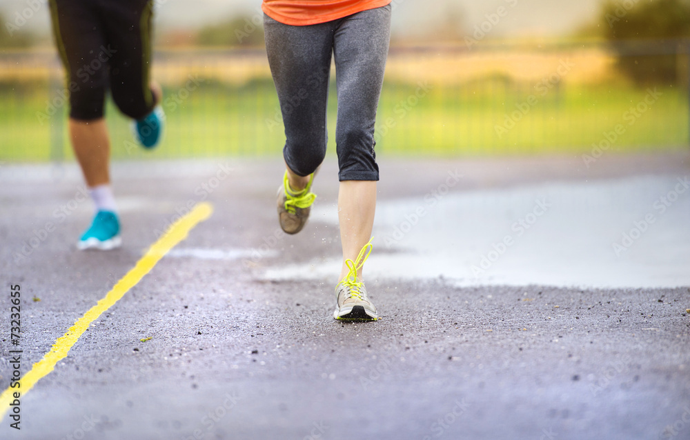 Couple running in rainy weather Couple running in rainy weather