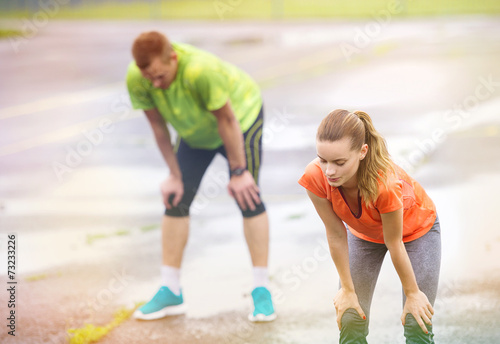 Couple stretching in rainy weather