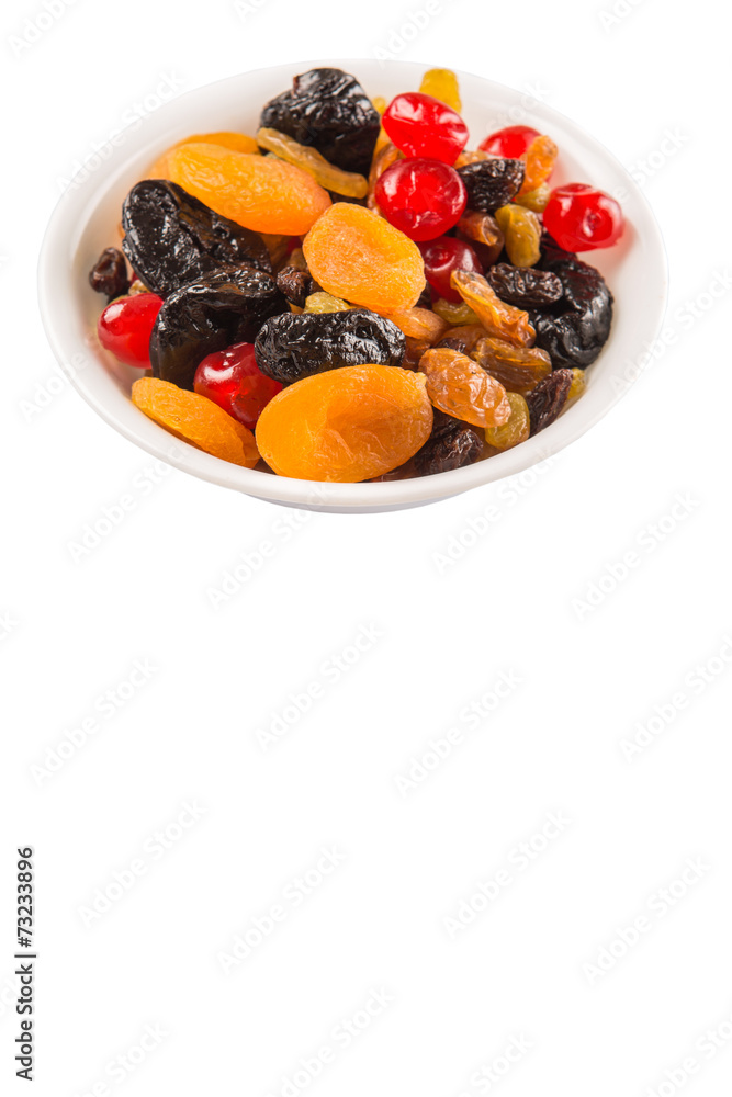 Mix variety of dried fruit in white bowl over white background Mix variety of dried fruit in white bowl over white background