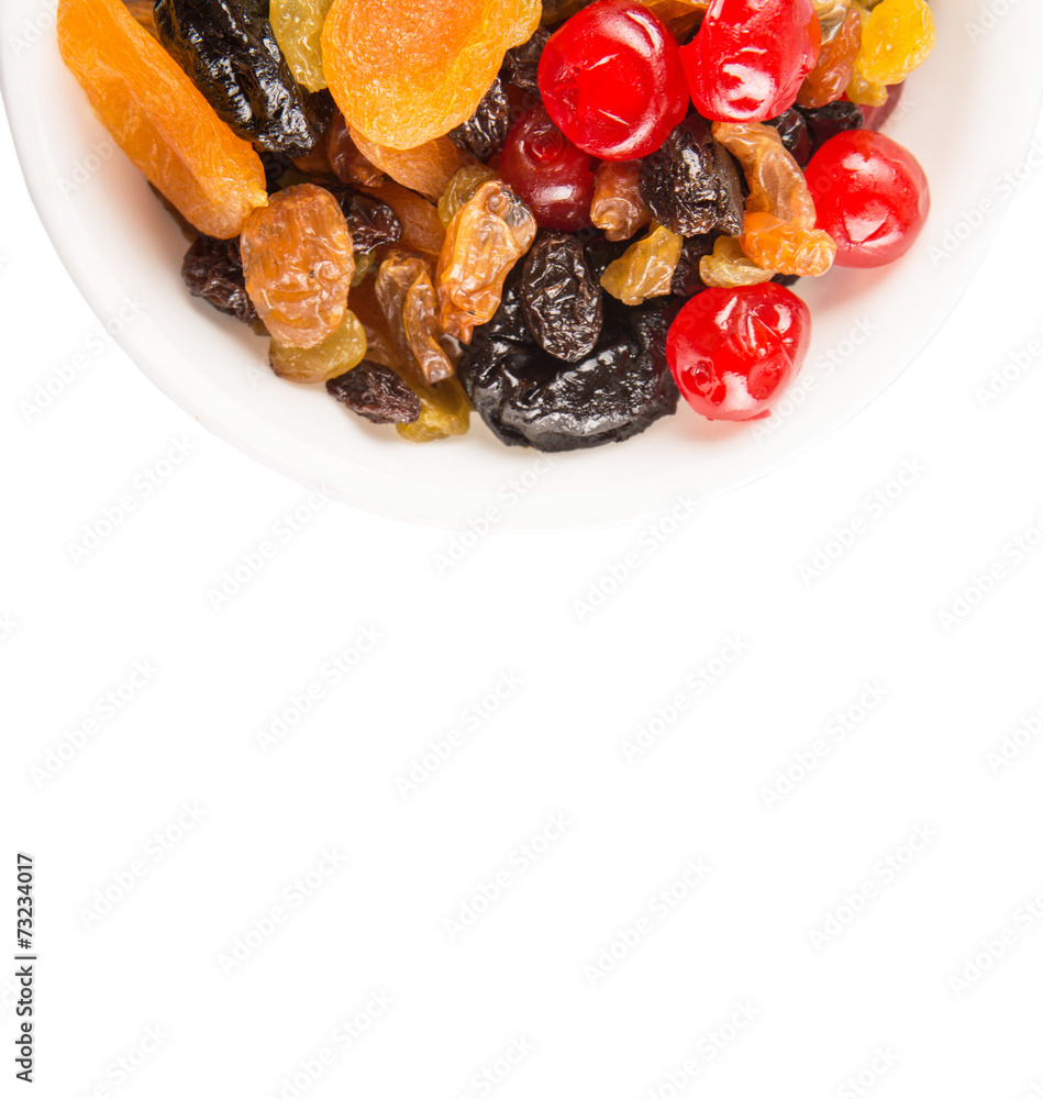 Mix variety of dried fruit in white bowl over white background Mix variety of dried fruit in white bowl over white background