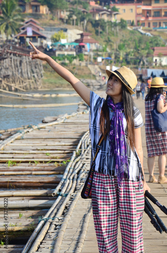 Thai Women with tripod portrait at Antique bamboo bridge photo