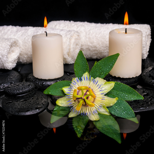 spa still life of passiflora flower  green leaf with drop  towel