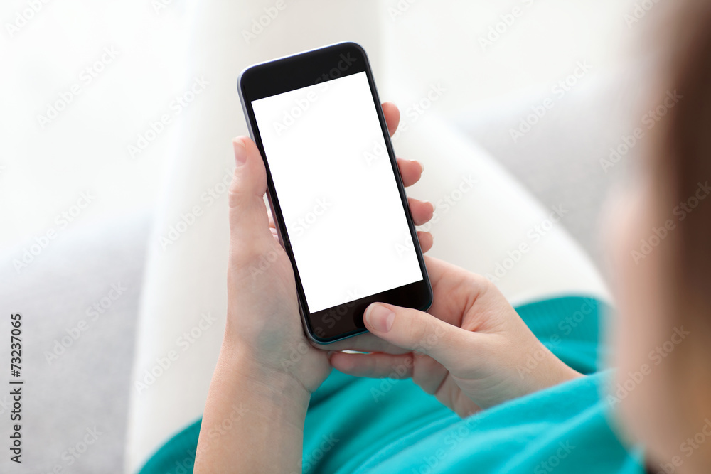 woman holding a phone with isolated screen on a sofa