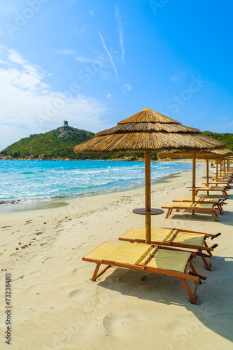 Fototapeta Naklejka Na Ścianę i Meble -  Sunchairs with umbrellas on Porto Giunco beach, Sardinia island
