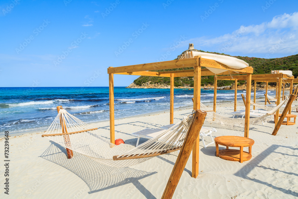 Hammocks and chairs on sandy Porto Giunco beach, Sardinia island Hammocks and chairs on sandy Porto Giunco beach, Sardinia island