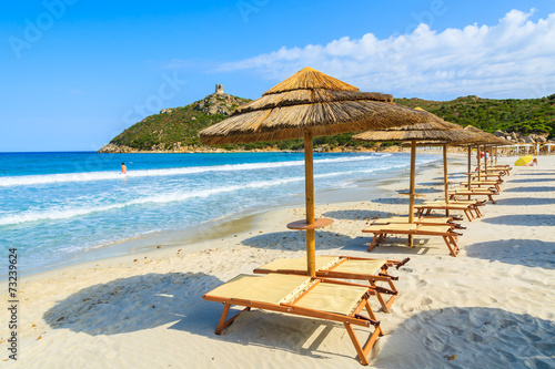 Fototapeta Naklejka Na Ścianę i Meble -  Villasimius beach with sunchairs and umbrellas, Sardinia island